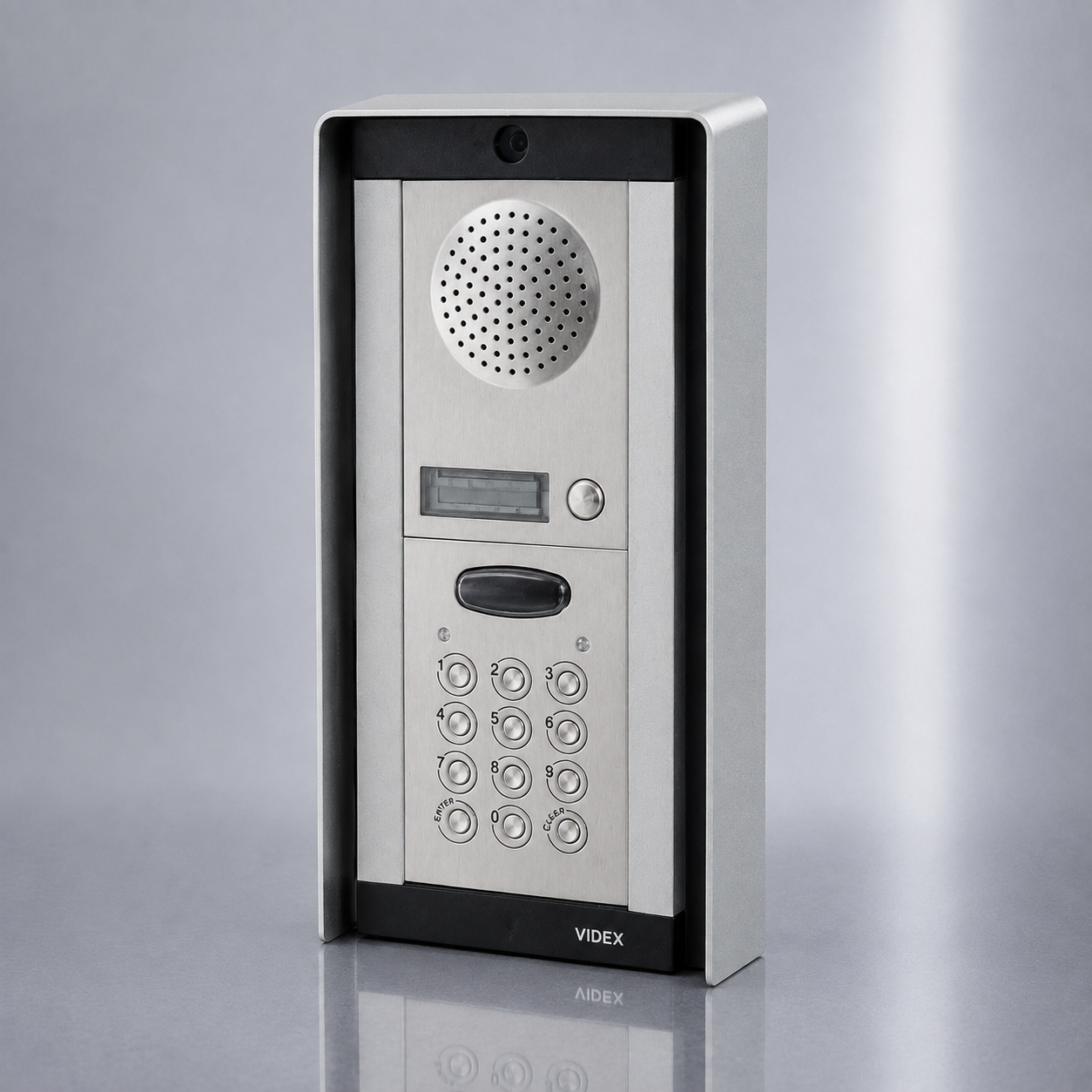 A VIDEX indoor intercom and keypad unit with a brushed silver metal faceplate and black trim, shown on a reflective gray studio background.