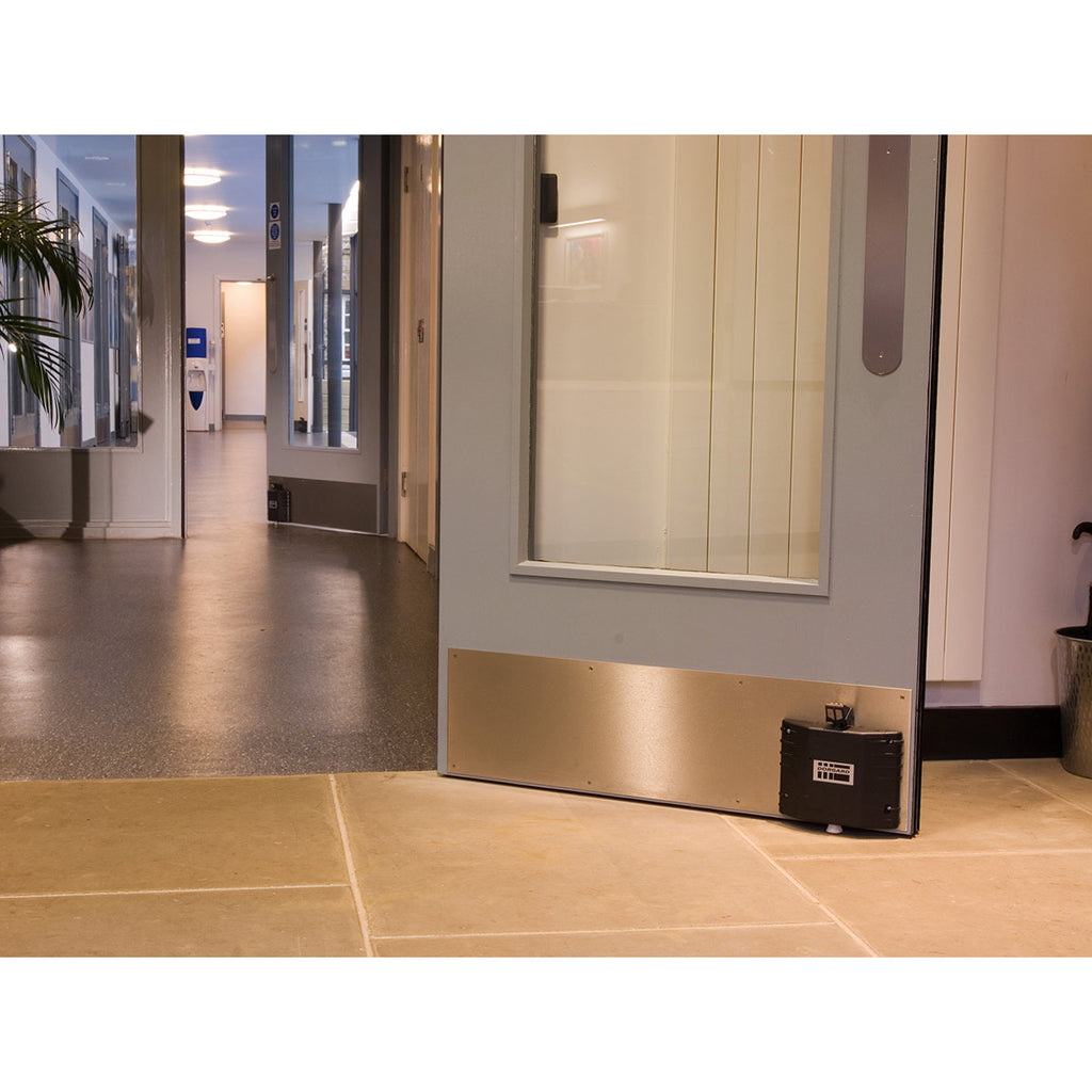 Fireco Dorgard DG2000 acoustic fire door retainer fitted at the bottom of a fire door