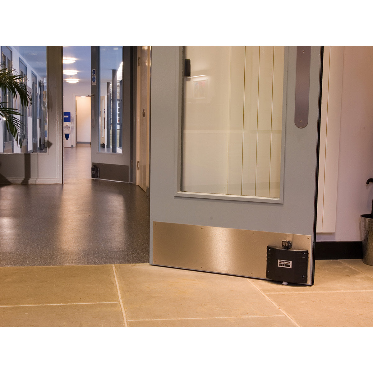 Fireco Dorgard DG2000 acoustic fire door retainer fitted at the bottom of a fire door