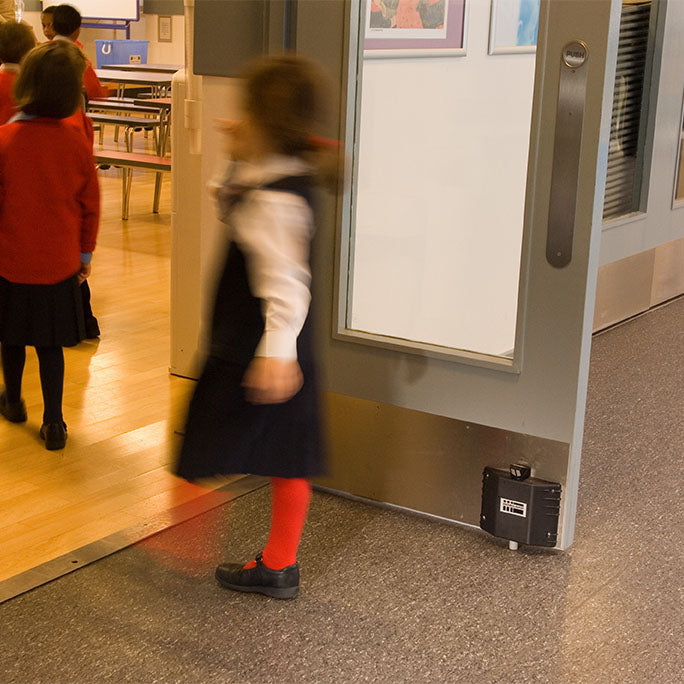Fireco Dorgard SmartSound fire door hold-open device installed in a school